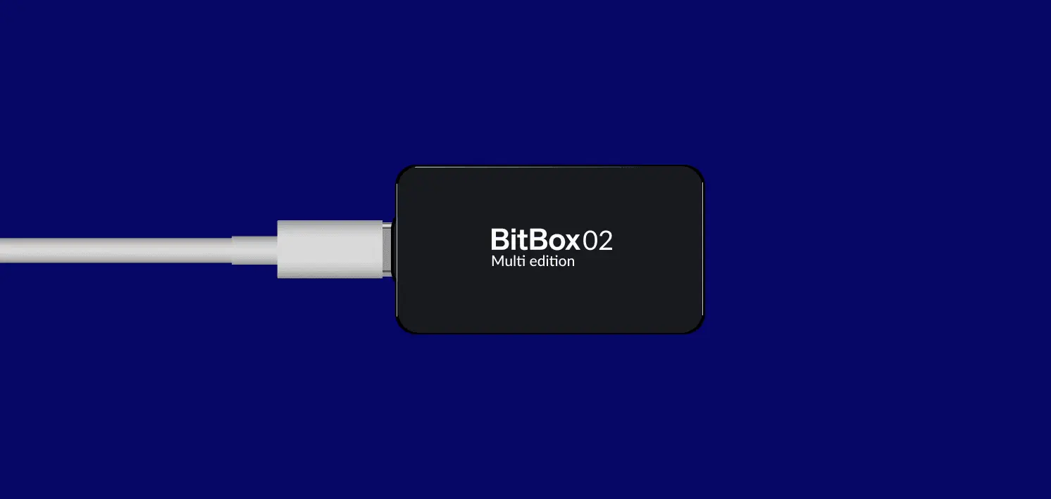 Bitbox hardware wallet connected via USB, showing the BitBox home screen on its display.